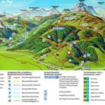 Illustrierte Wanderkarte eines Gebirgsortes mit Wander-, Radfahr- und Abenteuerrouten, Liften und Restaurantstandorten, mit Legende und Symbolen für verschiedene Einrichtungen und Aktivitäten.