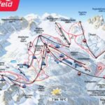 Karte des Skigebiets Nassfeld Hermagor mit Pisten, Liften, Berggipfeln mit Höhenangaben und der Talstation in Tröpolach. Rote, blaue und schwarze Linien zeigen unterschiedliche Schwierigkeitsgrade der Pisten an.