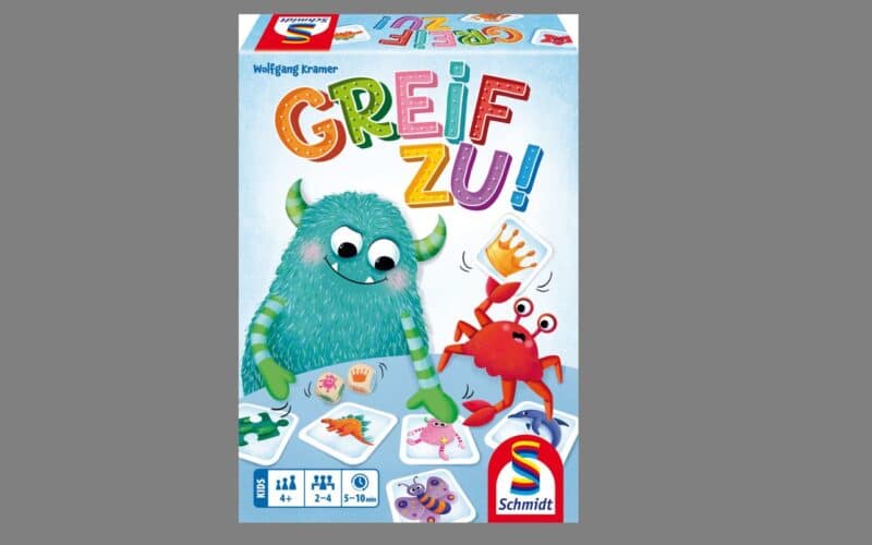 Die farbenfrohe Brettspielschachtel mit dem Titel "Greif Zu!" zeigt ein blaues Monster, eine rote Krabbe und illustrierte Spielkarten. Das Spiel ist für 2-5 Spieler, ab 5 Jahren, von Schmidt Spiele.