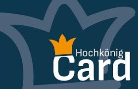 Logo mit weißem Umriss einer Krone auf dunklem Hintergrund, mit einer orangefarbenen Krone und dem Text "Hochkönig Card" in Weiß.