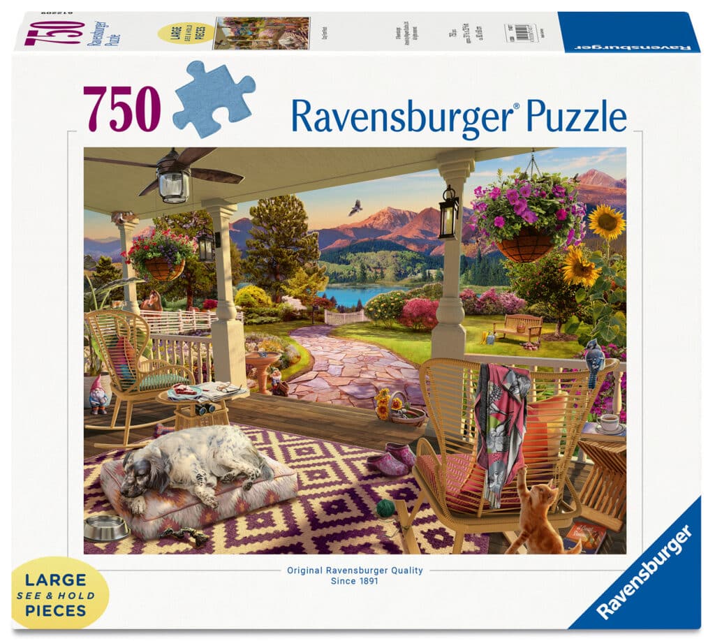 Ein 750-teiliges Ravensburger Puzzle mit einer illustrierten gemütlichen Verandaszene mit einem Hund, Schaukelstühlen, Blumen und einer Bergseelandschaft im Hintergrund.