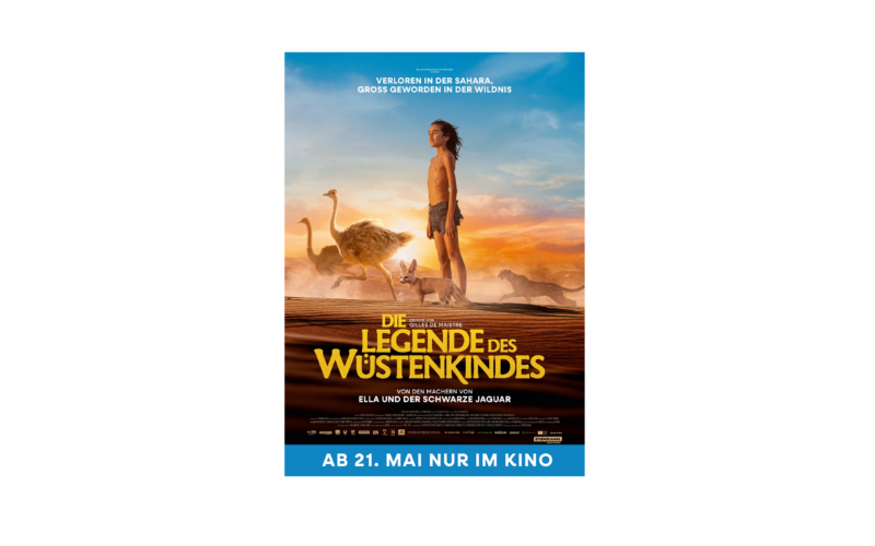 Ein Filmplakat für "Die Legende des Wüstenkindes" zeigt ein Kind mit Tieren in einer Wüste bei Sonnenuntergang, mit dem Erscheinungsdatum "Ab 21. Mai nur im Kino" am unteren Rand.