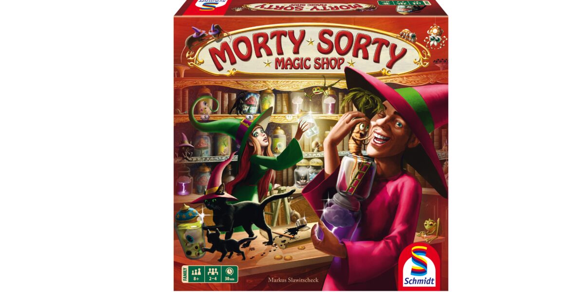 Die Verpackung des Brettspiels „Morty Sorty Magic Shop“ zeigt zwei Comic-Hexen, eine schwarze Katze und magische Gegenstände in einem farbenfrohen Laden. In der Ecke ist das Logo von Schmidt Spiele zu sehen.